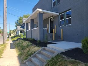 Lima apartment for rent - A grey house with a white door and windows.