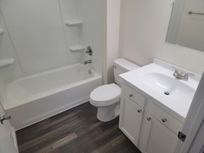 Lima apartment for rent - A white toilet sits next to a sink in a bathroom.