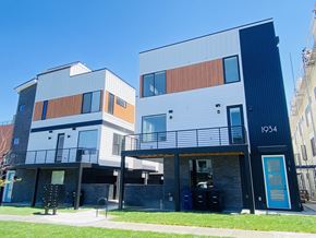 Denver apartment for rent - A modern two story building with a balcony on the first floor.