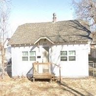 Norman house for rent - a white house with a wooden deck in front of it