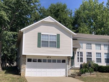 Lenexa apartment for rent - a white house with a white garage door