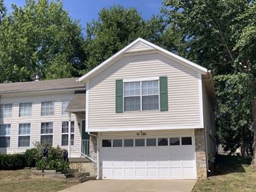 Lenexa apartment for rent - a white house with a white garage door