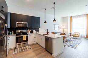 Worcester apartment for rent - A modern kitchen with a refrigerator, oven, and sink.
