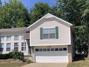 Lenexa apartment for rent - a white house with a white garage door
