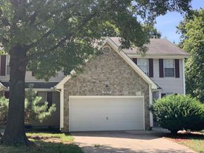Lenexa apartment for rent - a stone house with a white garage door