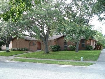 Corpus Christi house for rent - A tree in front of a brick building.