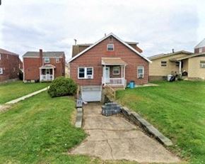 West Mifflin apartment for rent - A brick house with a white door and a small front yard.