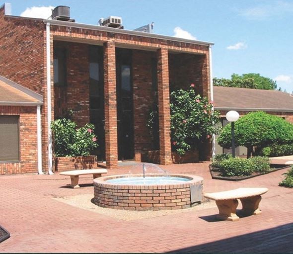 Gretna apartment for rent - a fountain in front of a brick building