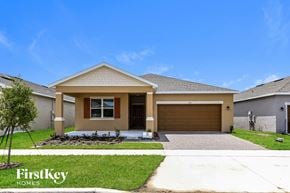 Kissimmee house for rent - a house with a driveway and a garage door