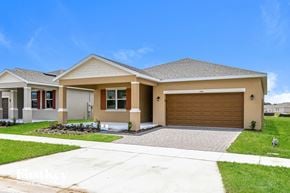 Kissimmee house for rent - a house with a driveway and a garage door