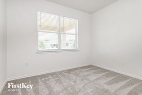 Kissimmee house for rent - a bedroom with a window and a carpeted floor