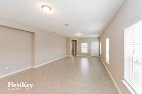 Yulee house for rent - a spacious living room with a large window and a tiled floor