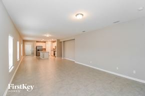 Yulee house for rent - an empty living room with a kitchen in the background