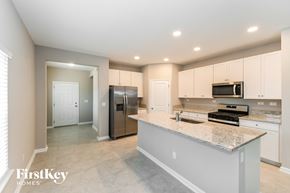Yulee house for rent - a large kitchen with stainless steel appliances and granite counter tops