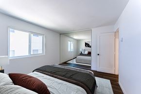 Spring Valley apartment for rent - a bedroom with a large bed and a mirror in the middle
