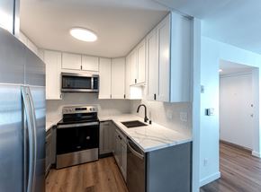 Spring Valley apartment for rent - a kitchen with white cabinets and stainless steel appliances