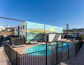 Spring Valley apartment for rent - a swimming pool with a mural on the side of a building
