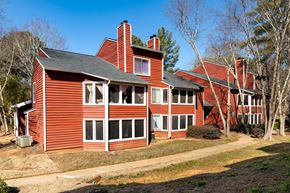 Lawrenceville apartment for rent - a red house with a black roof and some trees