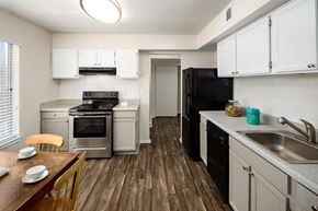 Lawrenceville apartment for rent - a kitchen with stainless steel appliances and white cabinets
