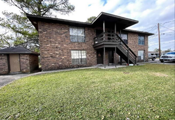 Thibodaux apartment for rent - A house with a balcony and a tree in front.