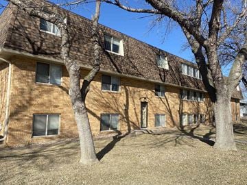 Kearney apartment for rent - a brick building with trees in front of it