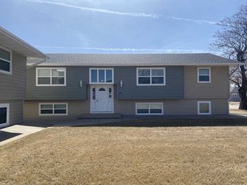 Kearney apartment for rent - a gray house with a white door and a yard