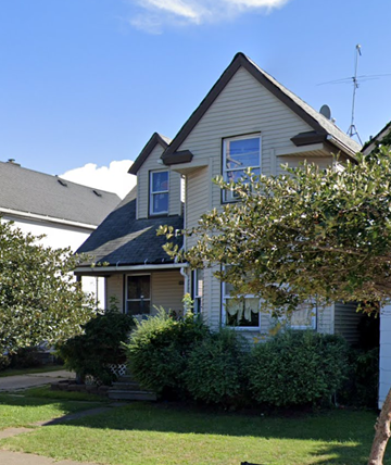 Cleveland apartment for rent - a house with a lawn and bushes in front of it