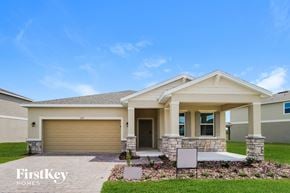 Kissimmee house for rent - A house with a garage and a front porch is for sale.
