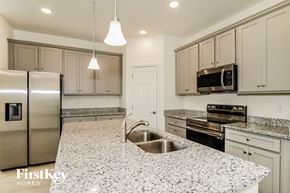 Kissimmee house for rent - A kitchen with granite countertops and stainless steel appliances.