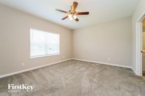 Yulee house for rent - the master bedroom has a carpeted floor and a ceiling fan