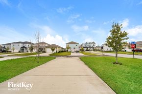 Yulee house for rent - a suburban street with houses and green grass and a sidewalk