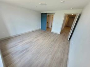 Bedford apartment for rent - A room with wooden flooring and a blue door.