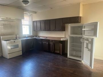 Chester apartment for rent - A kitchen with a white fridge and a white oven.