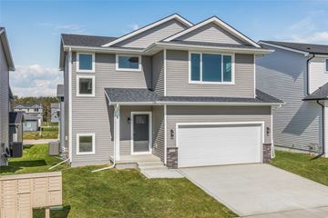 Urbandale apartment for rent - a house with a white garage door and a driveway