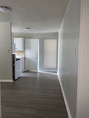Austin apartment for rent - A long hallway with a white door at the end.