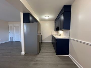 Roanoke apartment for rent - a kitchen with black cabinets and a stainless steel refrigerator