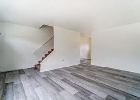 Lima apartment for rent - a white room with a staircase and wood floors