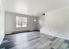 Lima apartment for rent - an empty living room with white walls and wood floors