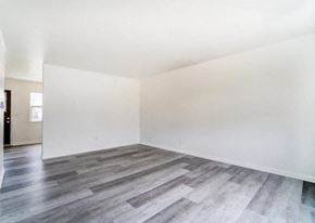 Lima apartment for rent - an empty room with white walls and wood floors