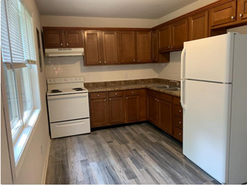 Lima apartment for rent - a kitchen with white appliances and wooden cabinets