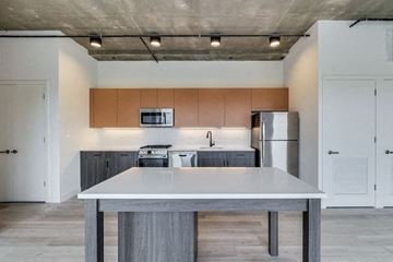 Chicago apartment for rent - A modern kitchen with a table in the middle.