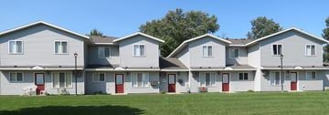 Sauk Centre apartment for rent - a row of houses with red doors and white siding