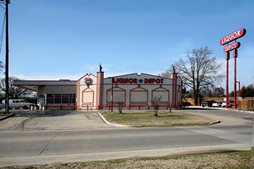 Bedford apartment for rent - A liquor depot building with a red and white sign.
