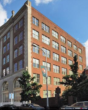 Philadelphia apartment for rent - a tall brick building with a flag in front of it