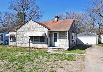 Springfield house for rent - a small white house with a yard and a sidewalk