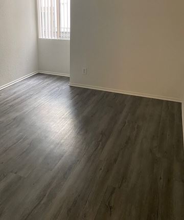 Van Nuys apartment for rent - an empty living room with wooden floors and a window