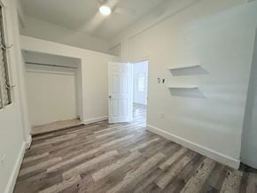San Juan apartment for rent - A room with wooden flooring and white walls.