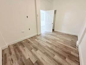 San Juan apartment for rent - A room with a white door and wooden flooring.