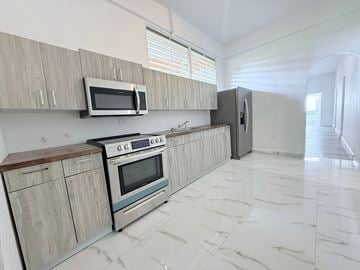 San Juan apartment for rent - A kitchen with a stove, oven, and microwave.