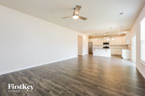 Greenville house for rent - A spacious room with wooden flooring and a ceiling fan.